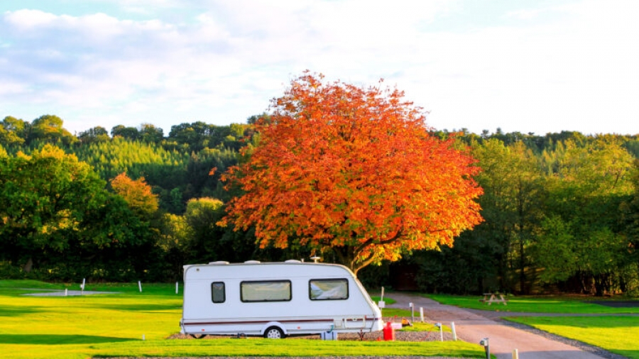 Caravan trailer in autumn holiday park